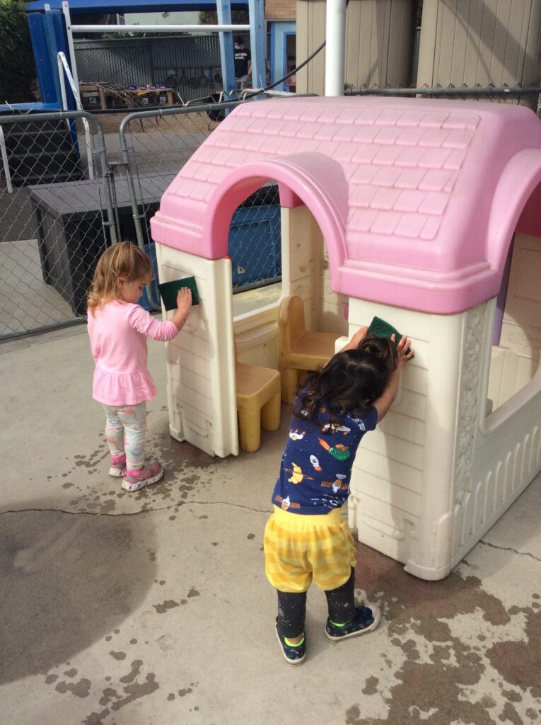 Toddler cleaning at preschool